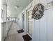 Building hallway with light blue walls and nautical wreath at 143 94Th Ave # 2, Treasure Island, FL 33706