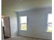 Bright bedroom featuring two large windows providing ample natural light, with plush carpeting at 16025 7Th E Ave, Bradenton, FL 34212