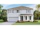 Two-story home with gray siding, gray shutters, a two-car garage, and well-manicured landscaping at 16025 7Th E Ave, Bradenton, FL 34212
