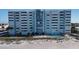 Beachfront building with pool and lush landscaping at 17400 Gulf Blvd # I5, Redington Shores, FL 33708
