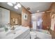 Clean bathroom with a tub shower, vanity, and mirrored medicine cabinet at 17400 Gulf Blvd # I5, Redington Shores, FL 33708