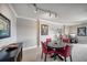 Dining room with round table and red chairs at 17400 Gulf Blvd # I5, Redington Shores, FL 33708