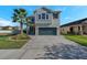 Two-story house with a green garage door and landscaped front yard at 21246 Southern Charm Dr, Land O Lakes, FL 34637