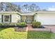 House exterior with stone accents and double doors at 2222 Westchester Blvd, Spring Hill, FL 34606