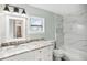 Modern bathroom with marble tile and updated vanity at 2537 Martha Ln, Land O Lakes, FL 34639