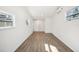 Bright bedroom with wood-look flooring and large windows at 2537 Martha Ln, Land O Lakes, FL 34639