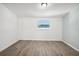Simple bedroom with wood-look floors and window at 2537 Martha Ln, Land O Lakes, FL 34639