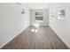 Well-lit bedroom with wood-look floors and a window at 2537 Martha Ln, Land O Lakes, FL 34639