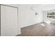 Bright bedroom with wood-look floors and closet at 2537 Martha Ln, Land O Lakes, FL 34639