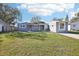 Newly renovated light blue house with a large yard and driveway at 2537 Martha Ln, Land O Lakes, FL 34639