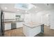 Modern kitchen with white cabinets and granite island at 2537 Martha Ln, Land O Lakes, FL 34639