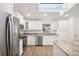 Modern kitchen with white cabinets and granite island at 2537 Martha Ln, Land O Lakes, FL 34639
