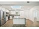 Modern kitchen with white cabinets and granite island at 2537 Martha Ln, Land O Lakes, FL 34639