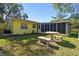 Backyard view of home with screened porch at 2609 Meadowbrook Dr, Palm Harbor, FL 34684