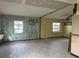 Large living room with damaged walls and tiled floor at 2620 S 19Th St, St Petersburg, FL 33712