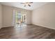 Bedroom with wood-look flooring, ceiling fan and sliding glass doors to patio at 3206 W Azeele St # 100, Tampa, FL 33609