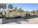 Inviting exterior of a light yellow building with palm trees and ample parking at 3206 W Azeele St # 100, Tampa, FL 33609