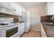 Efficient kitchen featuring white cabinets, granite countertops, and modern appliances at 3206 W Azeele St # 100, Tampa, FL 33609