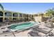 Community pool with lounge chairs and patio furniture at 3206 W Azeele St # 100, Tampa, FL 33609