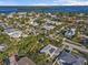 Aerial view of the home and surrounding neighborhood near the water at 35 Juniper Way, Clearwater Beach, FL 33767