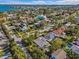 Wide aerial view showing home, neighborhood, and bay at 35 Juniper Way, Clearwater Beach, FL 33767