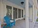 Inviting front porch features two blue chairs and ornate columns at 35 Juniper Way, Clearwater Beach, FL 33767