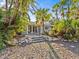 Single story home with tropical landscaping and walkway at 35 Juniper Way, Clearwater Beach, FL 33767