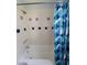 Clean bathroom with tub and shower, blue patterned curtain at 3631 4Th N Ave, St Petersburg, FL 33713