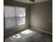Bright bedroom with large windows, wood-look tile flooring, and neutral walls at 3631 4Th N Ave, St Petersburg, FL 33713