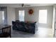 Living room with patterned couch, tiled floor, and decorative sun art at 3631 4Th N Ave, St Petersburg, FL 33713