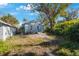 Backyard view of a house with a patio and lush greenery at 4264 46Th N St, St Petersburg, FL 33714