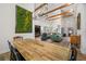 Farmhouse dining room with a long wooden table and a view into the living room at 4508 N Eddy Dr, Tampa, FL 33603