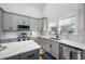 Modern kitchen features gray cabinets, white quartz countertops and stainless steel appliances at 4508 N Eddy Dr, Tampa, FL 33603