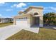 House exterior with a two-car garage and front yard at 4621 Dumont St, New Port Richey, FL 34653