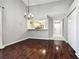 Bright dining room with dark wood floors and a view into the kitchen at 569 Daventry Sq, Palm Harbor, FL 34683