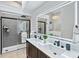 Modern bathroom with a double vanity, a glass-enclosed shower, and sleek fixtures at 637 Pinellas Bayway S # 207, Tierra Verde, FL 33715