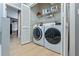 Bright laundry room with washer, dryer, and ample shelving at 637 Pinellas Bayway S # 207, Tierra Verde, FL 33715