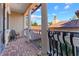 Balcony with brick flooring and wrought iron railings overlooking the neighborhood at 7713 Still Lakes Dr, Odessa, FL 33556