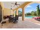 Covered patio with dining furniture and stunning pool views at 7713 Still Lakes Dr, Odessa, FL 33556