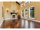 Spacious living room with hardwood floors, a large fireplace and high ceilings at 7713 Still Lakes Dr, Odessa, FL 33556