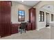 Home office with built-in desk and cabinets, carpeted floor, and a window at 7713 Still Lakes Dr, Odessa, FL 33556