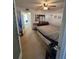 King bed, dresser, and view into hallway from bedroom at 8220 112Th St # 103, Seminole, FL 33772