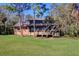 Brick house back with large deck and grassy yard at 9031 Baywood Park Dr, Seminole, FL 33777