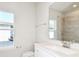 Modern bathroom with white vanity and tiled shower at 9803 Crescent Moon Dr, Riverview, FL 33578