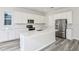 Modern kitchen featuring white cabinets, stainless steel appliances, and an island at 9803 Crescent Moon Dr, Riverview, FL 33578