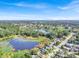 Wide aerial view of houses and lake, showcasing surrounding landscape at 12520 Shadow Ridge Blvd, Hudson, FL 34669