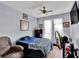 Cozy bedroom with a blue bedspread and a ceiling fan at 12520 Shadow Ridge Blvd, Hudson, FL 34669