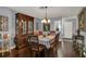 Elegant dining room featuring a wood table, chandelier, and hardwood floors at 12520 Shadow Ridge Blvd, Hudson, FL 34669