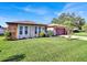 Single-story home with stone accents, landscaped lawn, and a paved driveway at 12520 Shadow Ridge Blvd, Hudson, FL 34669