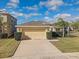 House exterior with driveway and landscaping at 15403 Fire Rock Pl, Ruskin, FL 33573